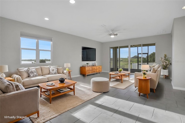 living room with ceiling fan and plenty of natural light