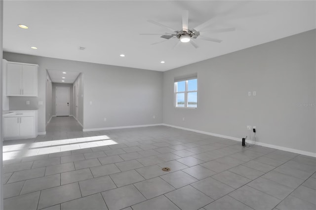 spare room featuring ceiling fan and light tile patterned floors