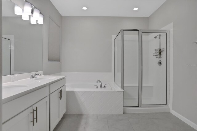 bathroom with tile patterned flooring, vanity, and separate shower and tub