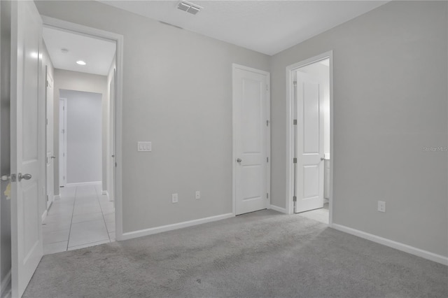 unfurnished bedroom featuring light carpet