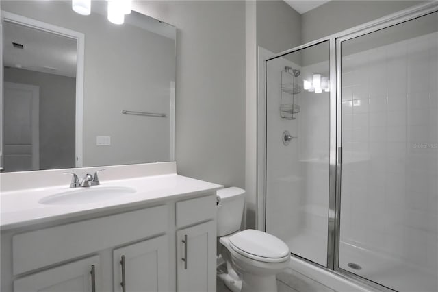 bathroom featuring vanity, toilet, and walk in shower