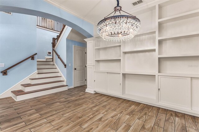 interior space with a notable chandelier and wood-type flooring