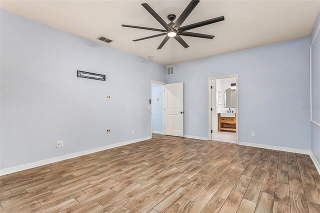 unfurnished bedroom featuring light hardwood / wood-style floors, ensuite bathroom, and ceiling fan