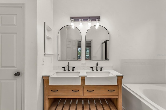 bathroom featuring vanity, hardwood / wood-style flooring, and a tub to relax in