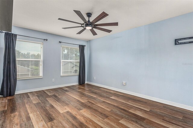 empty room with dark wood-type flooring and ceiling fan