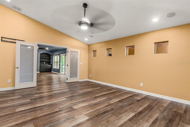 spare room with french doors, dark wood-type flooring, lofted ceiling, and ceiling fan