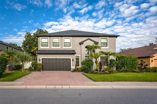 view of front property with a front yard and a garage