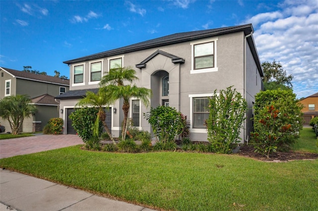 view of front of home with a front lawn and a garage