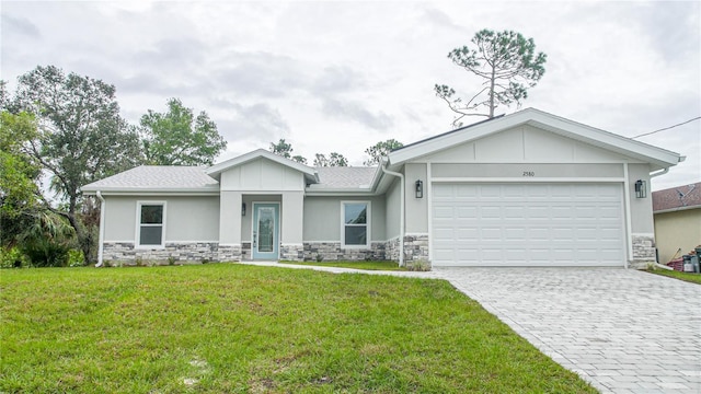 view of front of house with a garage and a front lawn