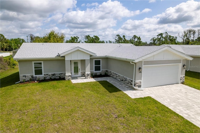 single story home with a garage and a front lawn