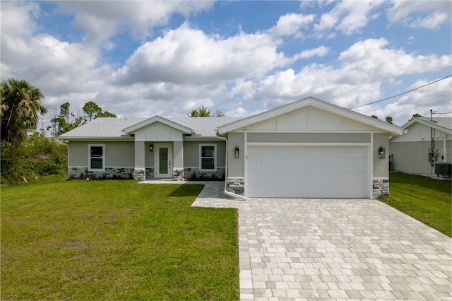 view of front of house featuring a garage and a front lawn