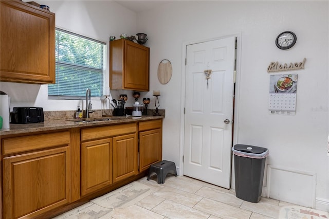 kitchen with light tile patterned floors and sink