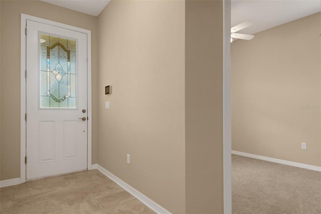 interior space featuring ceiling fan and light colored carpet