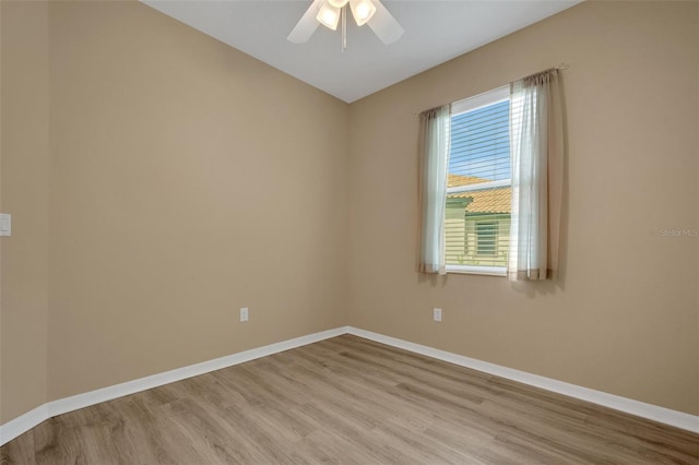 spare room featuring light hardwood / wood-style flooring and ceiling fan