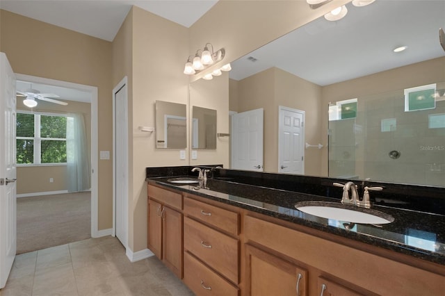 bathroom featuring tile patterned floors, ceiling fan, vanity, and tiled shower