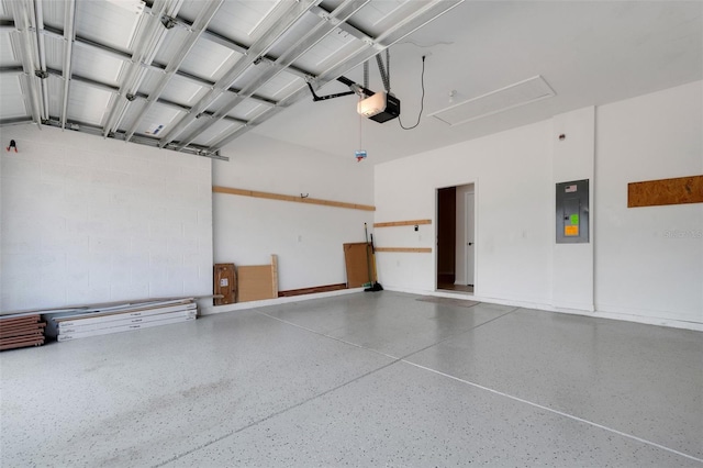 garage with a garage door opener and electric panel