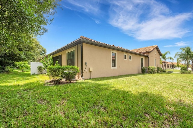 rear view of house featuring a yard