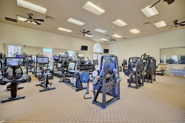 gym with ceiling fan and light carpet