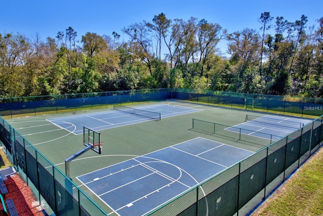 view of tennis court with basketball hoop