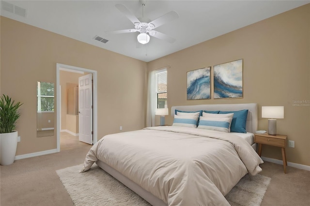 bedroom with light carpet and ceiling fan