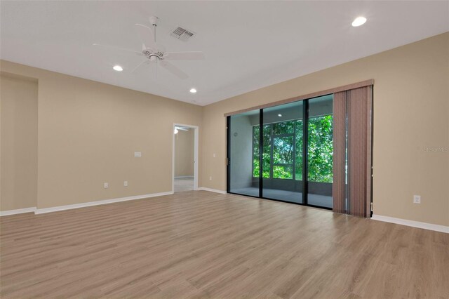 empty room with light hardwood / wood-style floors and ceiling fan