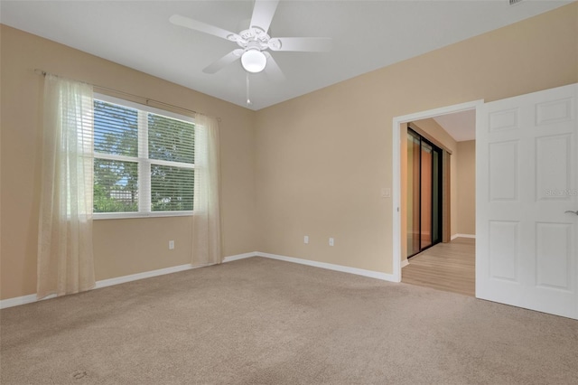 carpeted empty room featuring ceiling fan