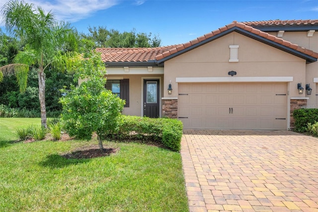 mediterranean / spanish-style house with a front yard and a garage