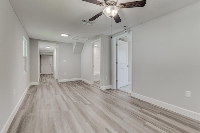 interior space featuring ceiling fan, a textured ceiling, and light hardwood / wood-style flooring