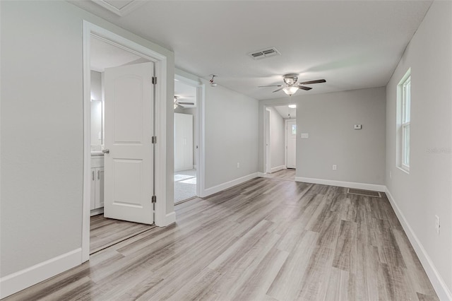 empty room featuring ceiling fan and light hardwood / wood-style floors