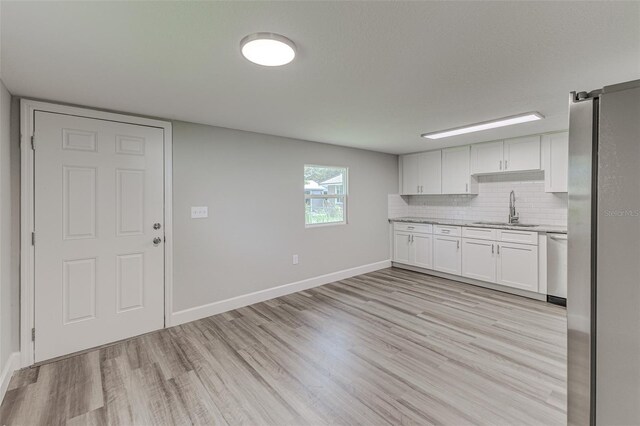 kitchen with sink, white cabinets, and light hardwood / wood-style floors