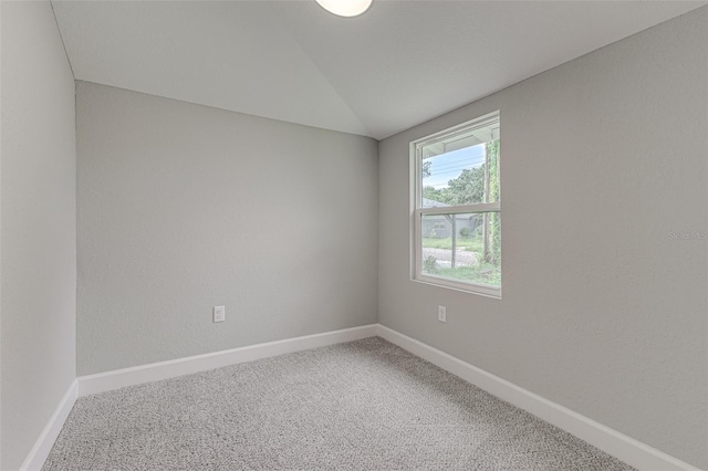 unfurnished room with lofted ceiling, carpet, and baseboards