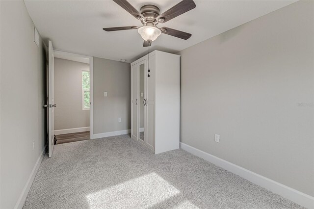 unfurnished bedroom featuring ceiling fan and light colored carpet