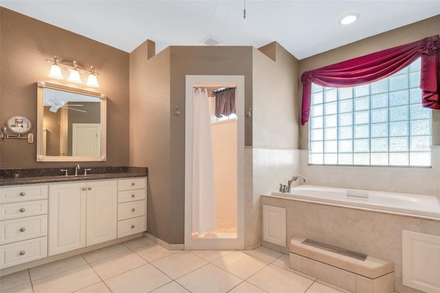 bathroom featuring tile patterned floors, ceiling fan, vanity, and independent shower and bath