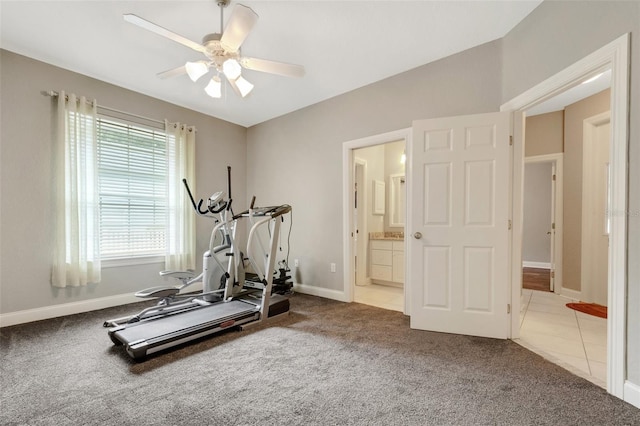 exercise area with light colored carpet and ceiling fan