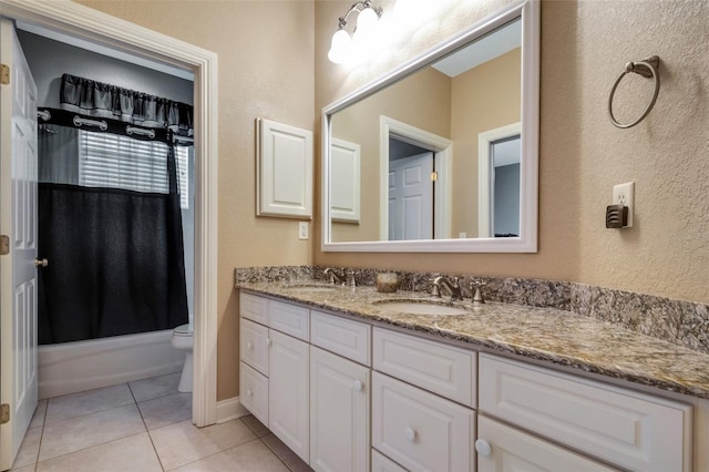 full bathroom featuring toilet, vanity, tile patterned flooring, and shower / bath combo