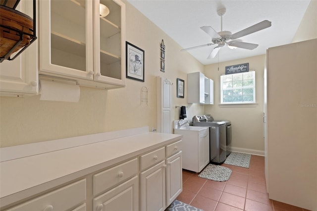 washroom featuring cabinets, light tile patterned floors, ceiling fan, and washing machine and clothes dryer