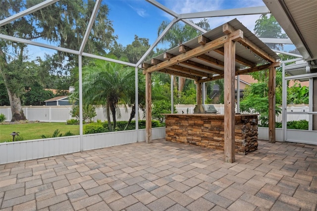 view of patio featuring exterior bar and exterior kitchen