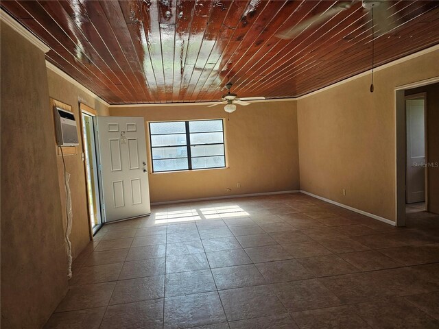 tiled empty room with a ceiling fan, wooden ceiling, a wall unit AC, and baseboards