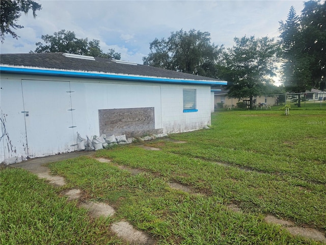 view of outbuilding featuring a yard