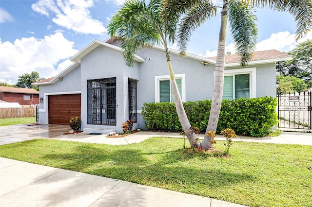 view of front facade featuring stucco siding, a front lawn, fence, concrete driveway, and a garage