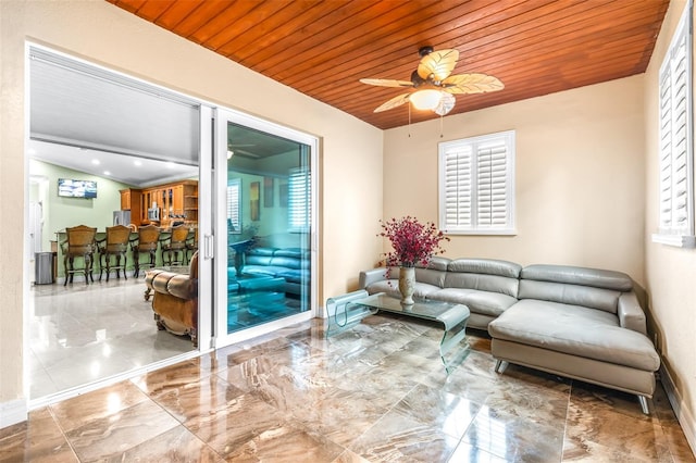 living room with baseboards, ceiling fan, vaulted ceiling, wooden ceiling, and marble finish floor