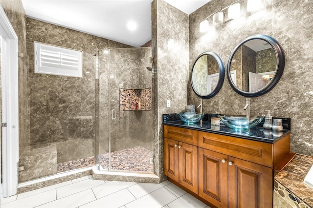 bathroom with a sink, a stall shower, and tile patterned floors