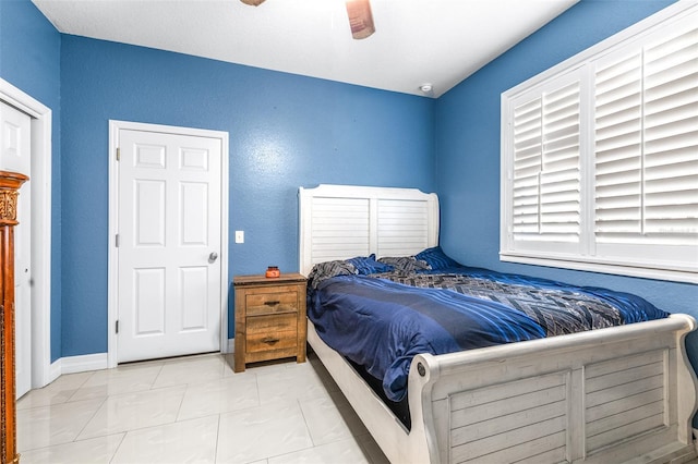 bedroom with baseboards and a ceiling fan