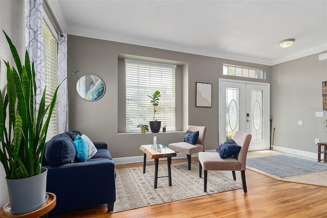 interior space featuring ornamental molding, french doors, wood finished floors, and baseboards