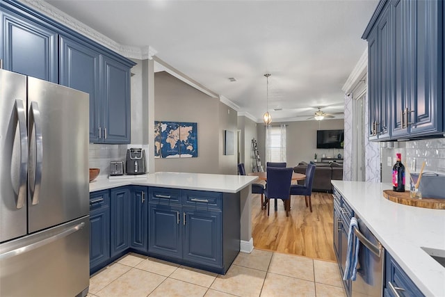 kitchen featuring stainless steel appliances, open floor plan, light tile patterned flooring, blue cabinets, and a peninsula