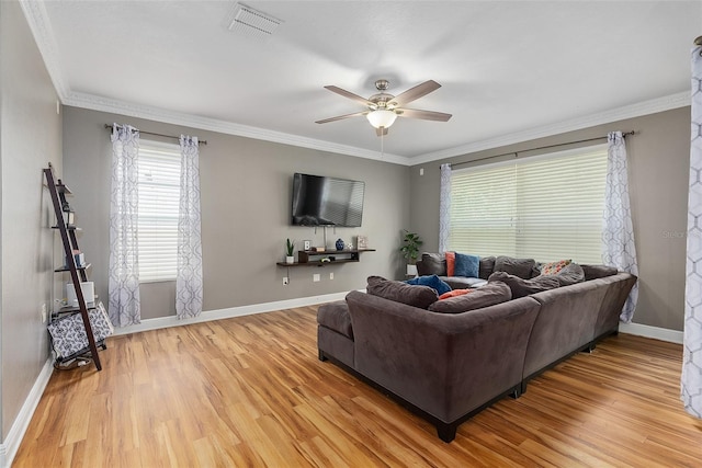 living room featuring hardwood / wood-style flooring, ceiling fan, and crown molding