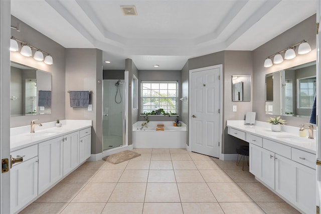 bathroom with separate shower and tub, vanity, tile patterned floors, and a tray ceiling