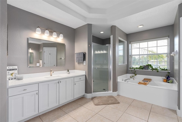 bathroom featuring plus walk in shower, tile patterned floors, and vanity