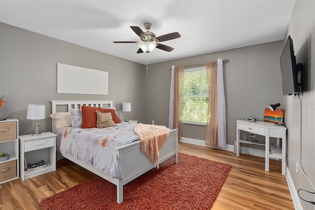 bedroom with ceiling fan and light hardwood / wood-style flooring