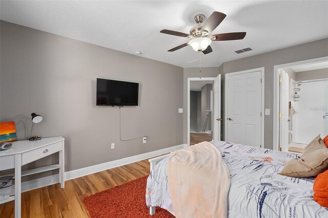 bedroom with ceiling fan and hardwood / wood-style flooring